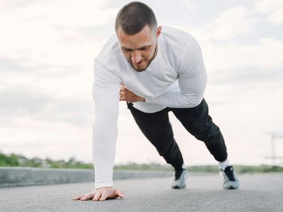 A man in mid-motion during a bodyweight exercise, showing control.